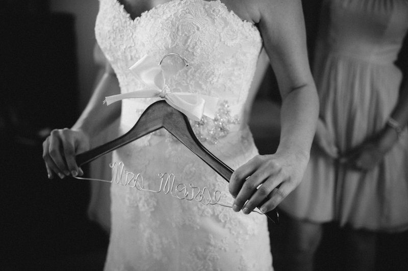 bride-holding-custom-wedding-dress-hanger